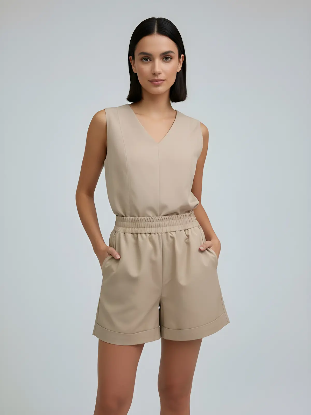 Minimal women’s set featuring a sleeveless top and tailored shorts in sand tone
