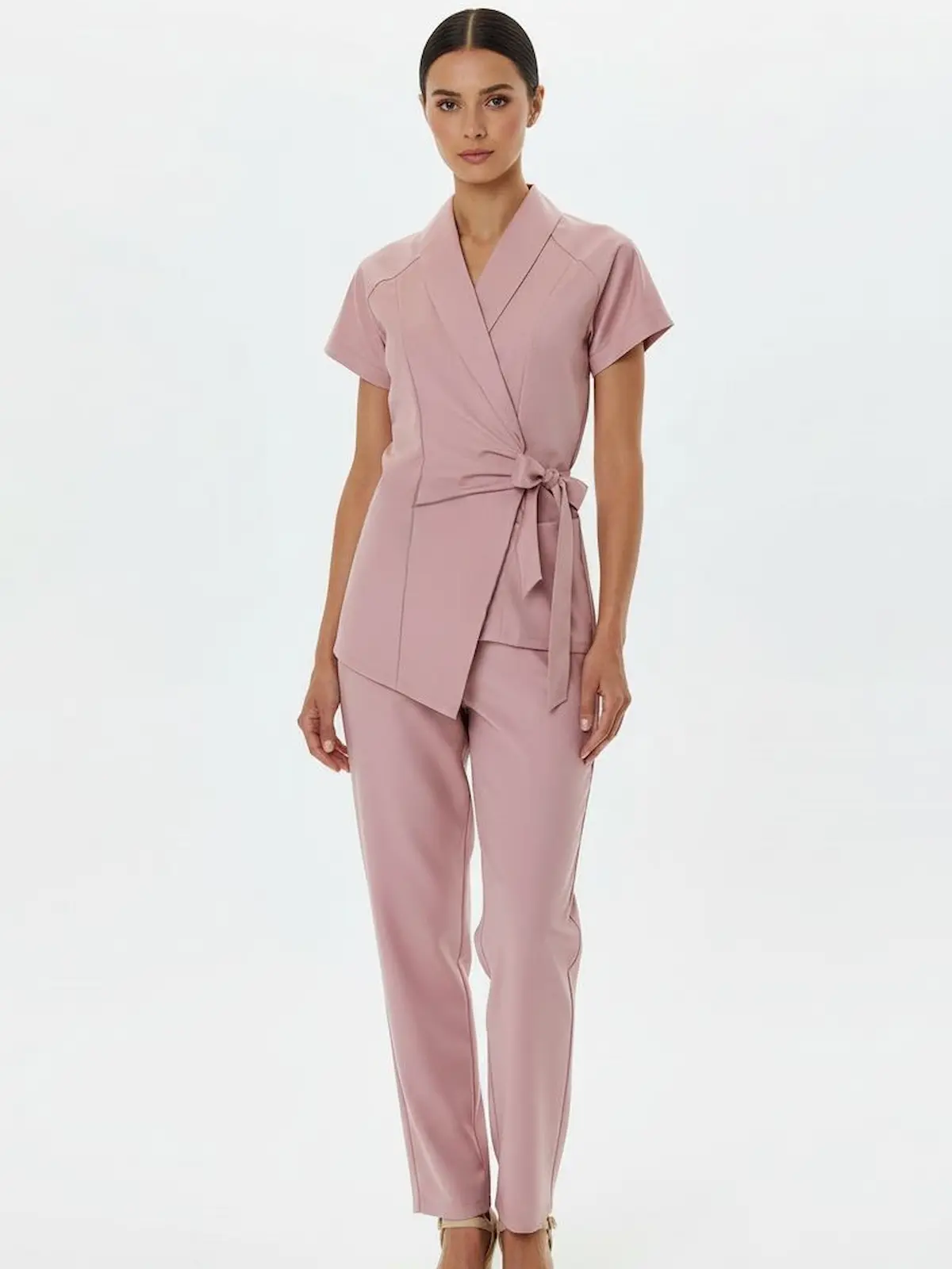 A modern housekeeping uniform featuring a wrap-style top with short sleeves and an elegant side tie for a refined, feminine silhouette.