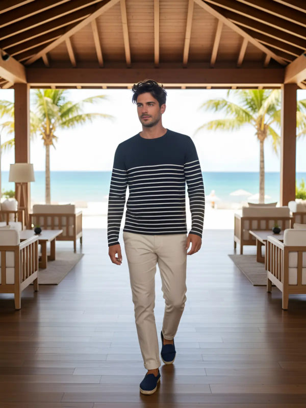 Modern resort look featuring a striped long-sleeve top and tailored trousers. Clean, relaxed and effortlessly elegant—perfect for beach resorts, lounge areas and refined summer settings.